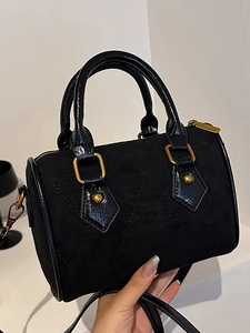 Retro black faux suede Boston bag with quilted texture and glossy leather trim detailing