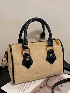 Beige faux suede Boston bag with white quilting and black patent leather handles