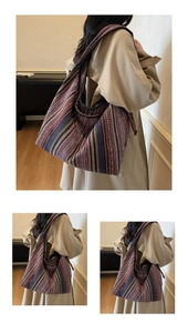 Close-up of bohemian striped tapestry tote bag with wide shoulder strap in casual setting