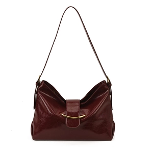 Deep burgundy vintage leather underarm bag with gold metal buckle on white background