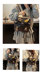 Detail of dark brown PU leather backpack with vintage buckles and cute plush brooches