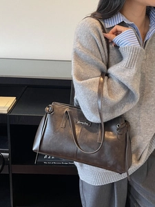 Retro dark brown underarm bag with Sunny Day metal logo and knot detail for daily commuting