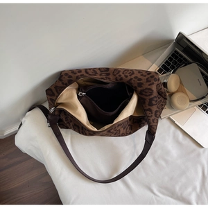 Detailed interior view of leopard print tote bag featuring brown zipper inner pouch