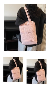 Detailed view of pink quilted nylon tote bag with front pocket and shoulder straps