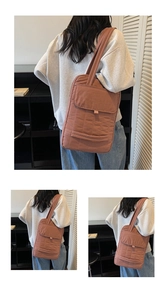 Close-up of terracotta quilted nylon tote bag with wide handles and front flap pocket