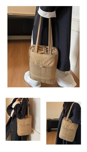 Detailed view of beige quilted laptop tote bag with long handles and front flap pocket