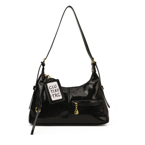 Glossy black vintage tote bag with gold hardware and shoulder strap for commuters