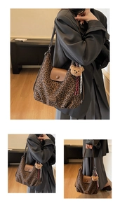 Detail view of leopard print hobo bag with brown leather flap and bear charm