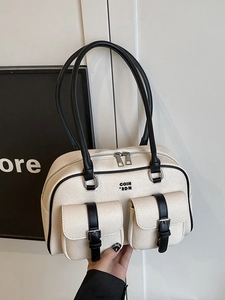 Retro canvas Boston bag with black leather handles and dual front pockets in off-white finish