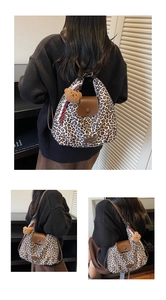 Detail of leopard print tote bag with brown leather flap and cute plush bear keychain