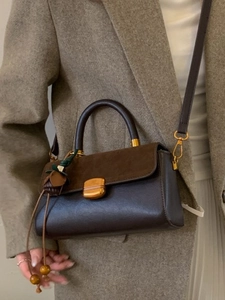 Vintage dark brown leather handbag for women featuring a gold buckle and shoulder strap