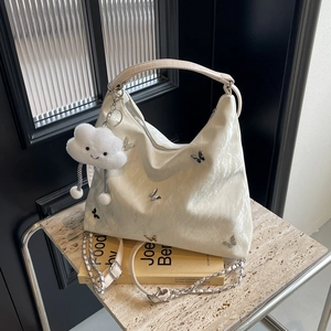 White pleated leather shoulder bag with butterfly ornaments and cloud charm detail