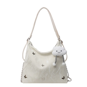 White pleated crossbody bag with silver butterfly charm and soft cloud keychain