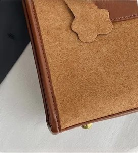 Close-up of premium suede stitching and petal leather detail on fashionable tote bag