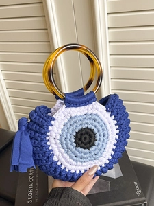 Handmade crochet evil eye handbag with tortoise resin handles and stylish blue side tassels