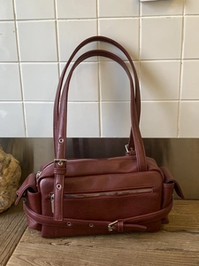 Retro burgundy faux leather motorcycle shoulder bag with vintage buckle straps and pockets