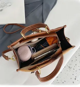 Spacious interior of brown lychee leather tote bag showing large capacity for accessories