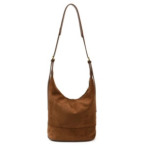 Retro brown suede bucket bag with a minimalist crescent shape and adjustable shoulder strap
