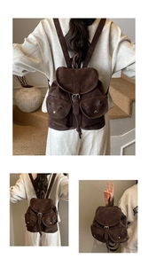Detail of vintage brown suede backpack featuring large flap closure and metal buckles