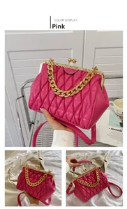 Close-up of pink matelassé handbag with retro metal clasp and thick gold chain strap