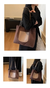 Detail view of brown suede tote bag featuring leather front pocket and metal chain strap