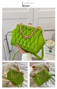 Detail of green quilted leather crossbody bag with vintage gold chain and clasp