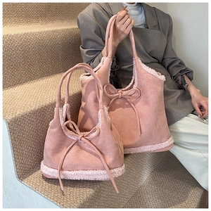 Detail view of pink frosted tote bags with plush sheepskin trim and bow decoration