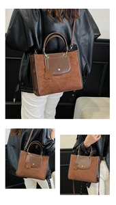 Detail of brown patchwork tote bag featuring metal buckle pocket and plush bear charm