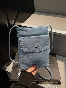 Stylish denim mini crossbody phone bag with washed blue fabric and silver snap button