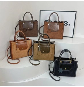 Multiple colors of matte tote bags with matching bear charms and leather pockets