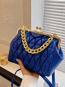 Blue quilted doctor bag with vintage gold metal frame and thick chain handle