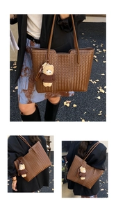 Close-up of woven brown leather tote bag with stylish bear pendant and white stitching details