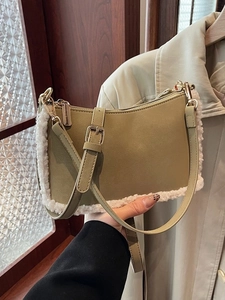 Olive green shoulder bag with lamb wool trim and adjustable strap in a daily street style
