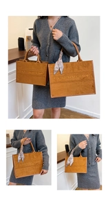 Detail view of large and medium brown suede tote bags with decorative paisley scarf