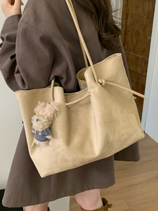 Large beige faux suede tote bag for women with minimalist knotted straps and dog charm