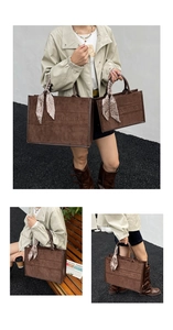 Detail of vintage brown suede tote bags in large and small sizes with decorative silk scarves