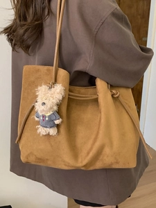 Brown faux suede tote bag with shoulder straps and cute dog plush charm detail