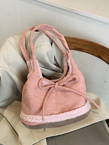 Pink faux suede tote bag with plush trim and bow detail for women's autumn winter style
