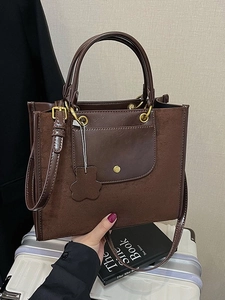 Fashionable dark brown tote bag with bear charm and adjustable shoulder strap for women