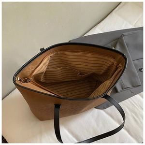 Detailed interior of the leopard print tote bag with striped lining and multiple compartments