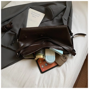 Deep brown tote bag showing spacious interior with tablet and daily essentials