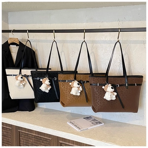 Detail shot of vintage leopard print tote bags in four colors with plush bear charms