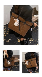 Detailed macro view of leopard print tote bag with plush puppy charm and black leather straps