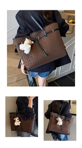 Close-up of leopard print tote bag with plush bear charm and black strap detail