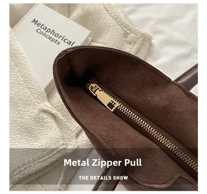 Detail of high-quality gold zipper and brown suede lining on a large vintage tote bag