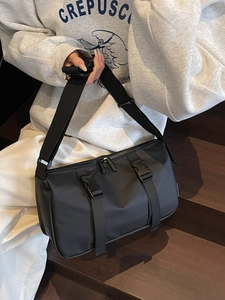Waterproof black nylon crossbody bag with dual buckles and adjustable wide shoulder strap