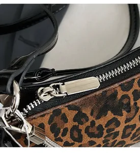Close-up of smooth silver metal zipper and hardware on leopard print crescent bag