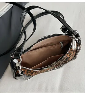 Top view of leopard print shoulder bag showing brown fabric lining and inner pockets