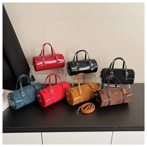 Detailed display of cylinder boston bags in various colors on a multi-level display stand