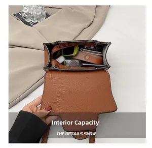 Internal view of brown pebbled leather handbag showing capacity for daily essentials